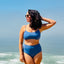 Woman standing confidently in cornflower blue bikini.